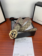 Gucci belt on display: beige GG canvas with gold-tone double G buckle