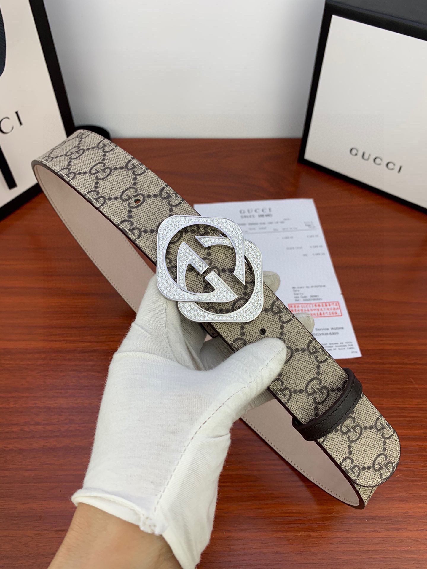 Gucci belt close-up: beige GG canvas with silver-tone double G buckle