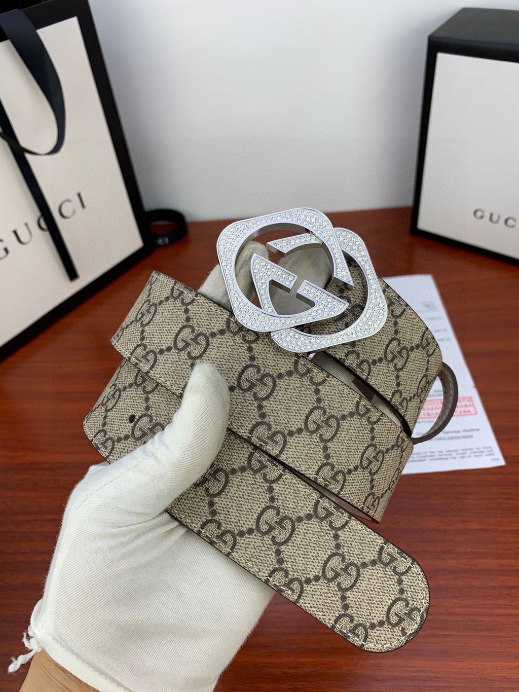 Gucci belt close-up: beige GG canvas with silver-tone crystal double G buckle