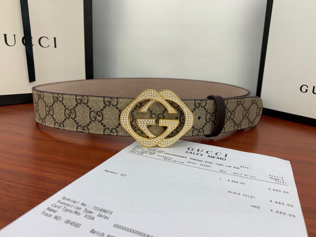 Gucci belt with beige GG canvas and gold-tone double G buckle, laid flat