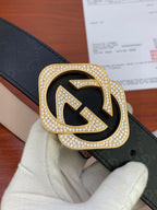 Gucci belt buckle close-up with crystal-studded GG logo on black strap
