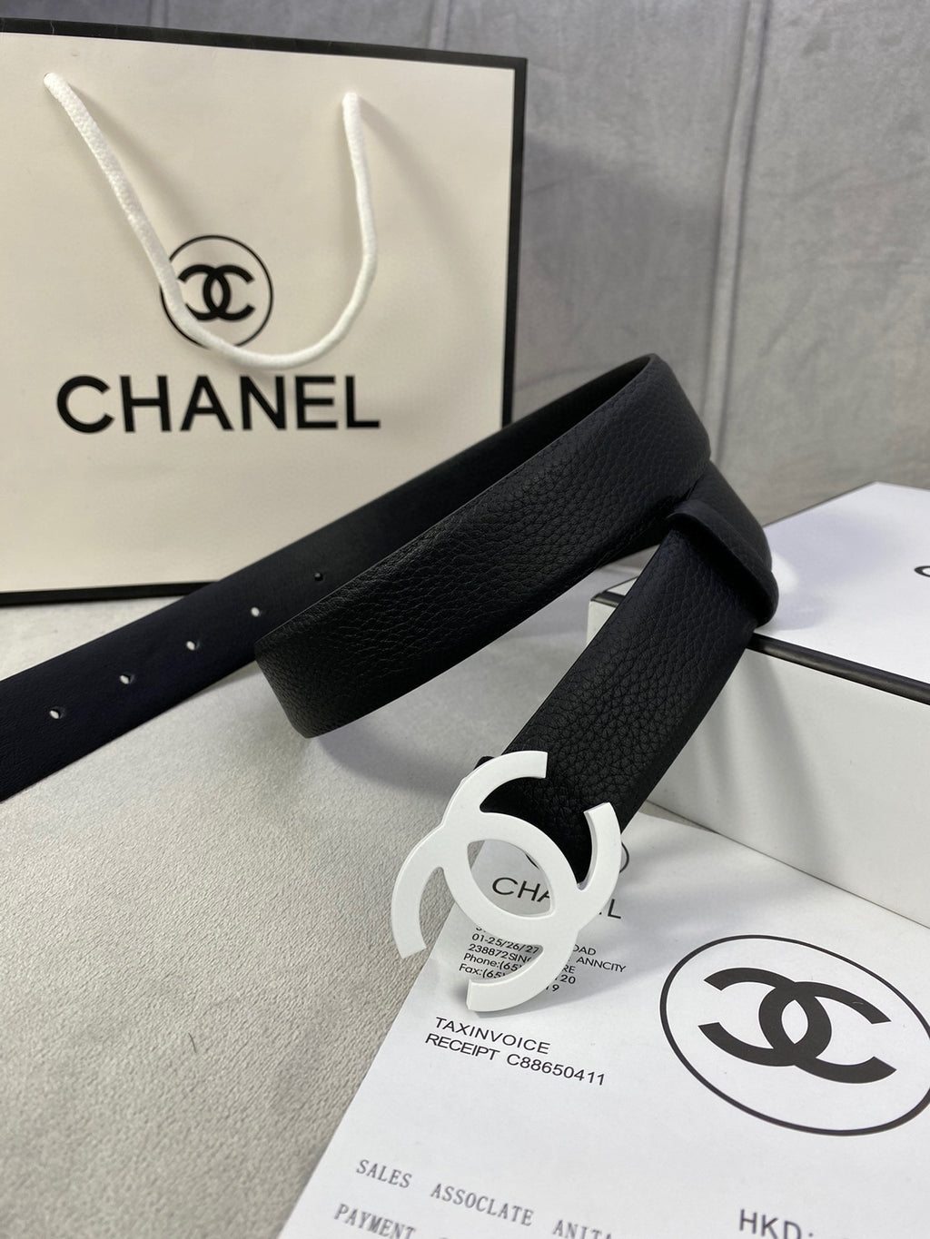 Chanel belt, black textured strap with silver CC buckle and punched adjustment holes.