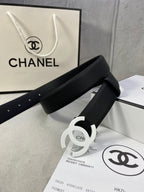Chanel belt, black textured strap with silver CC buckle and punched adjustment holes.