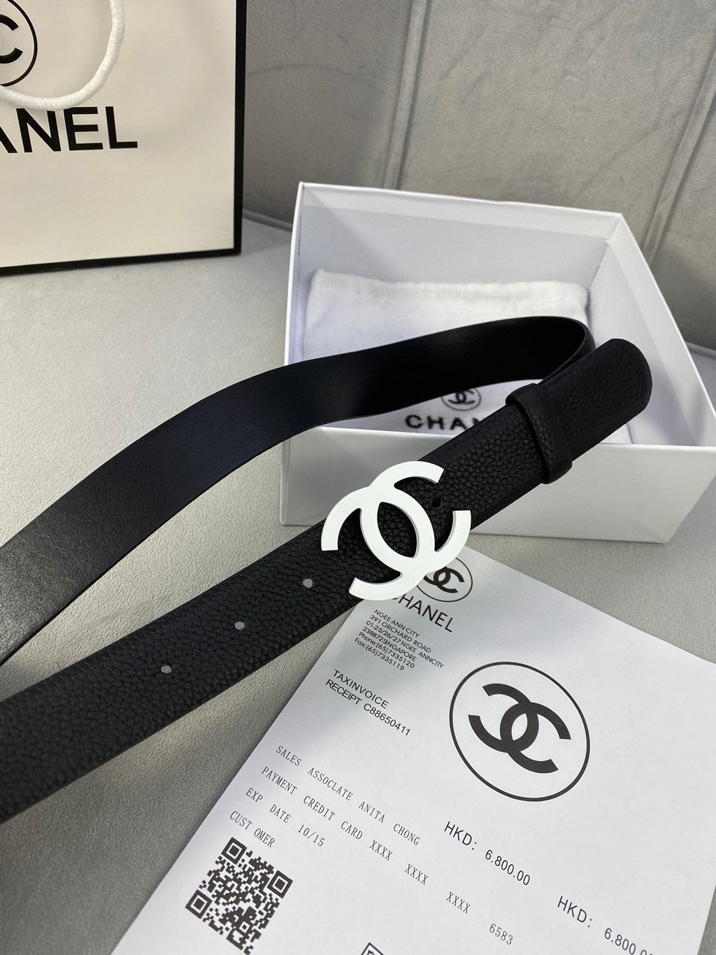 Chanel belt, black strap with silver CC buckle, shown in the product box.