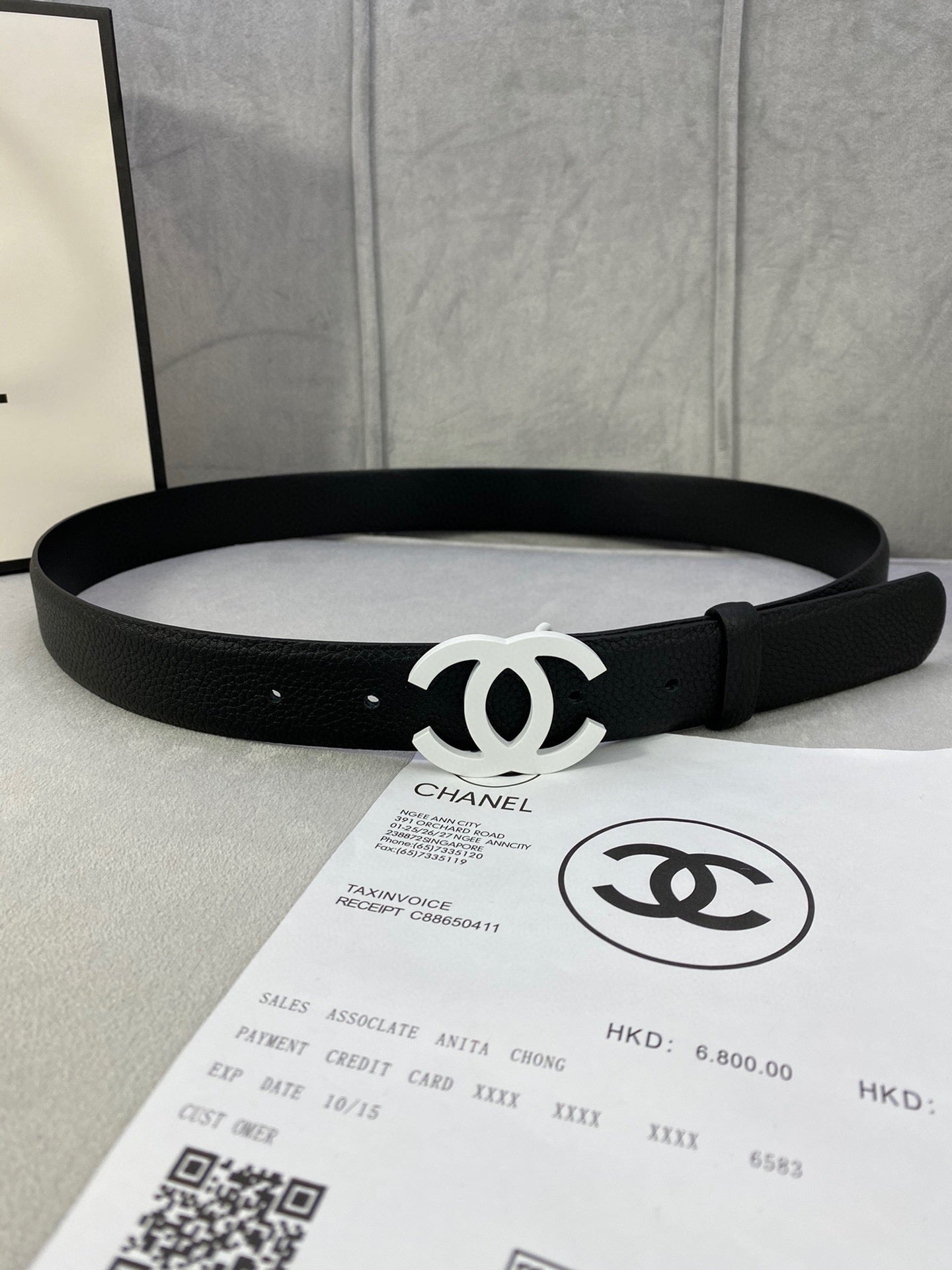 Chanel belt, black strap with silver CC logo buckle and multiple adjustment holes.