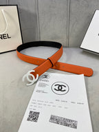 Chanel belt laid flat with orange leather strap and white CC buckle, shown with invoice