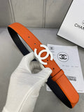 Chanel leather belt with orange strap, navy underside, and white CC buckle