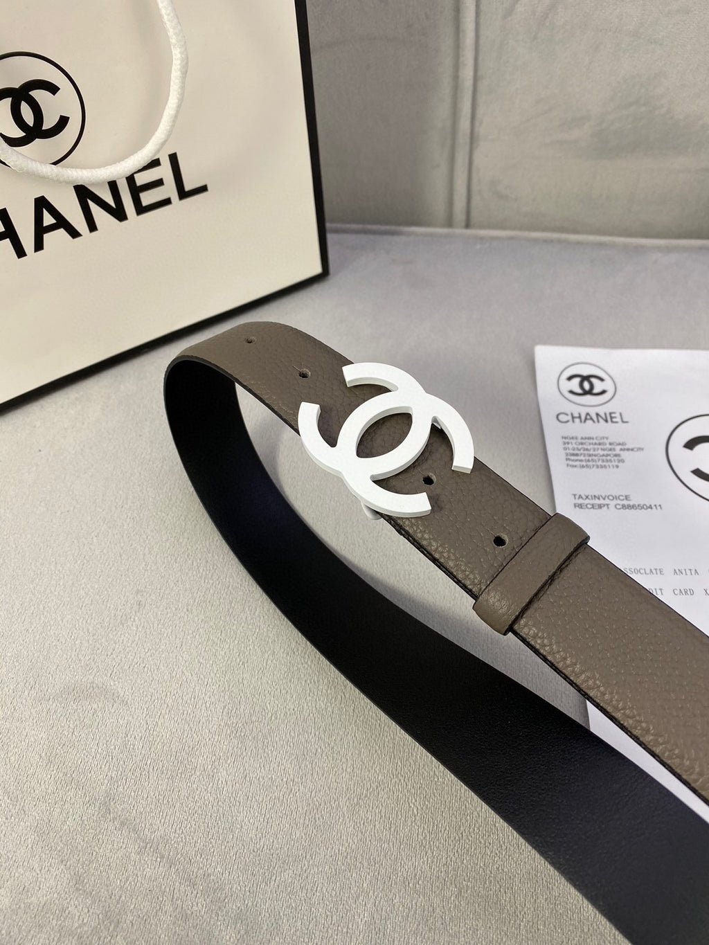 Dark olive leather belt with silver-tone interlocking CC buckle, wide strap