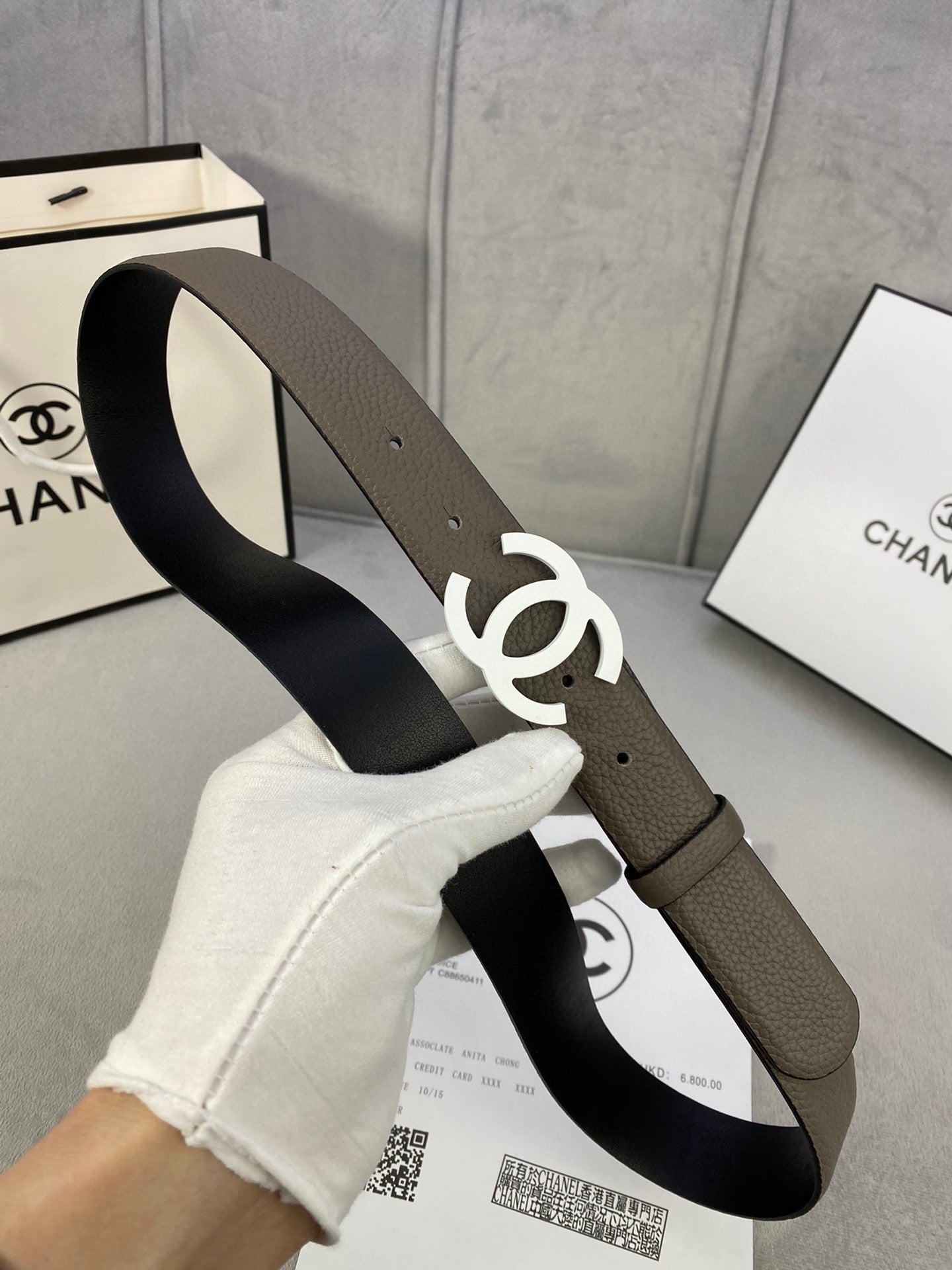Dark olive leather belt with silver-tone interlocking CC buckle, side view