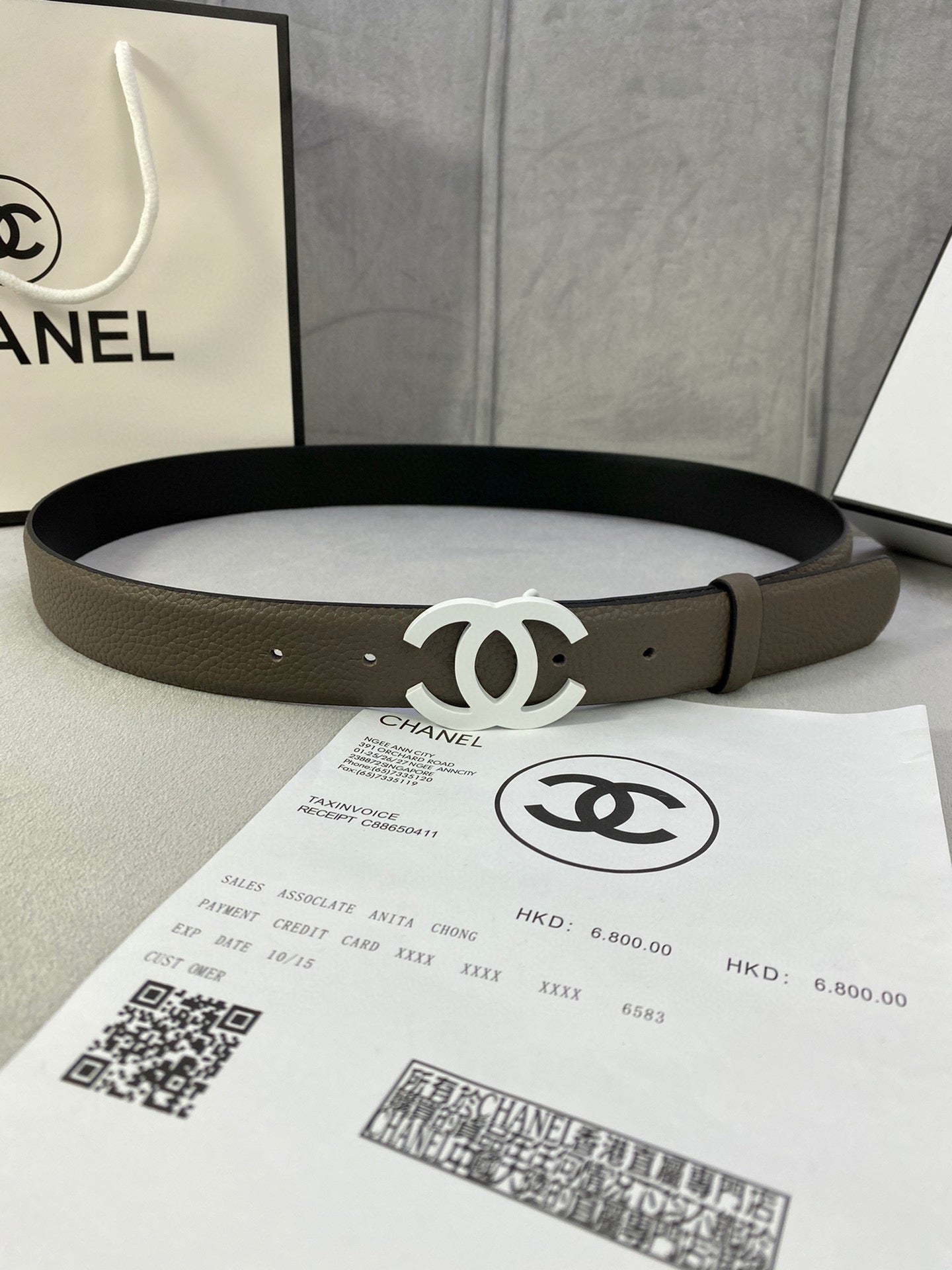 Dark olive leather belt with silver-tone interlocking CC buckle, flat wide strap