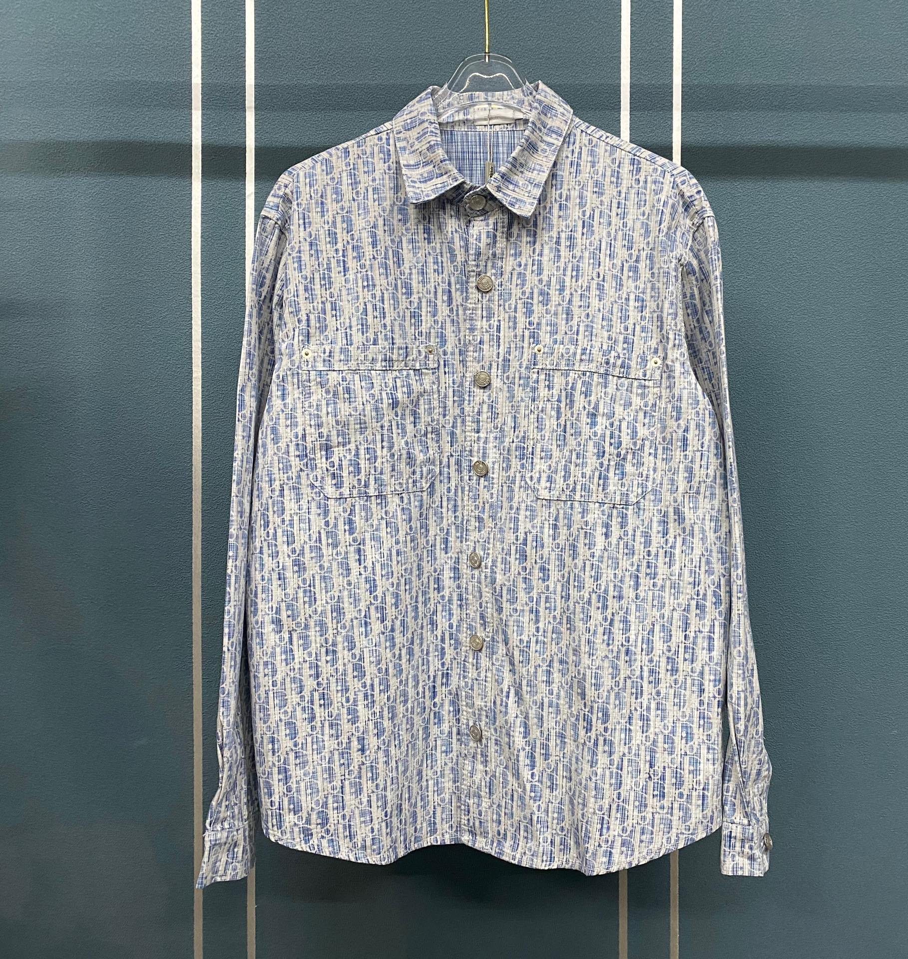 Blue and white patterned long-sleeve button-up shirt with pointed collar and buttons