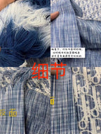 Blue and white patterned shirt fabric close-up with buttons and stitching