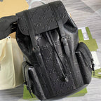 Black GG monogram backpack with front strap details and adjustable shoulder straps
