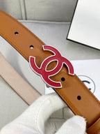 Close-up of brown Chanel belt with red CC emblem and strap hole perforations