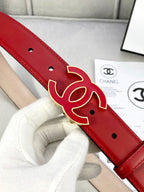 Red leather belt close-up of Chanel CC logo buckle with gold-tone outline