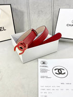 Red leather belt with Chanel CC logo buckle in open box with documents