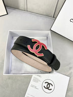 Chanel belt in dark leather with red-and-black CC logo on front, adjustable end.