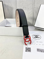 Chanel belt with dark leather strap, visible beige underside and red-and-black CC logo.
