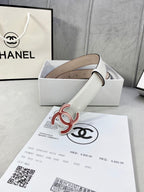 White Chanel belt with red logo buckle, smooth leather, and eyelets