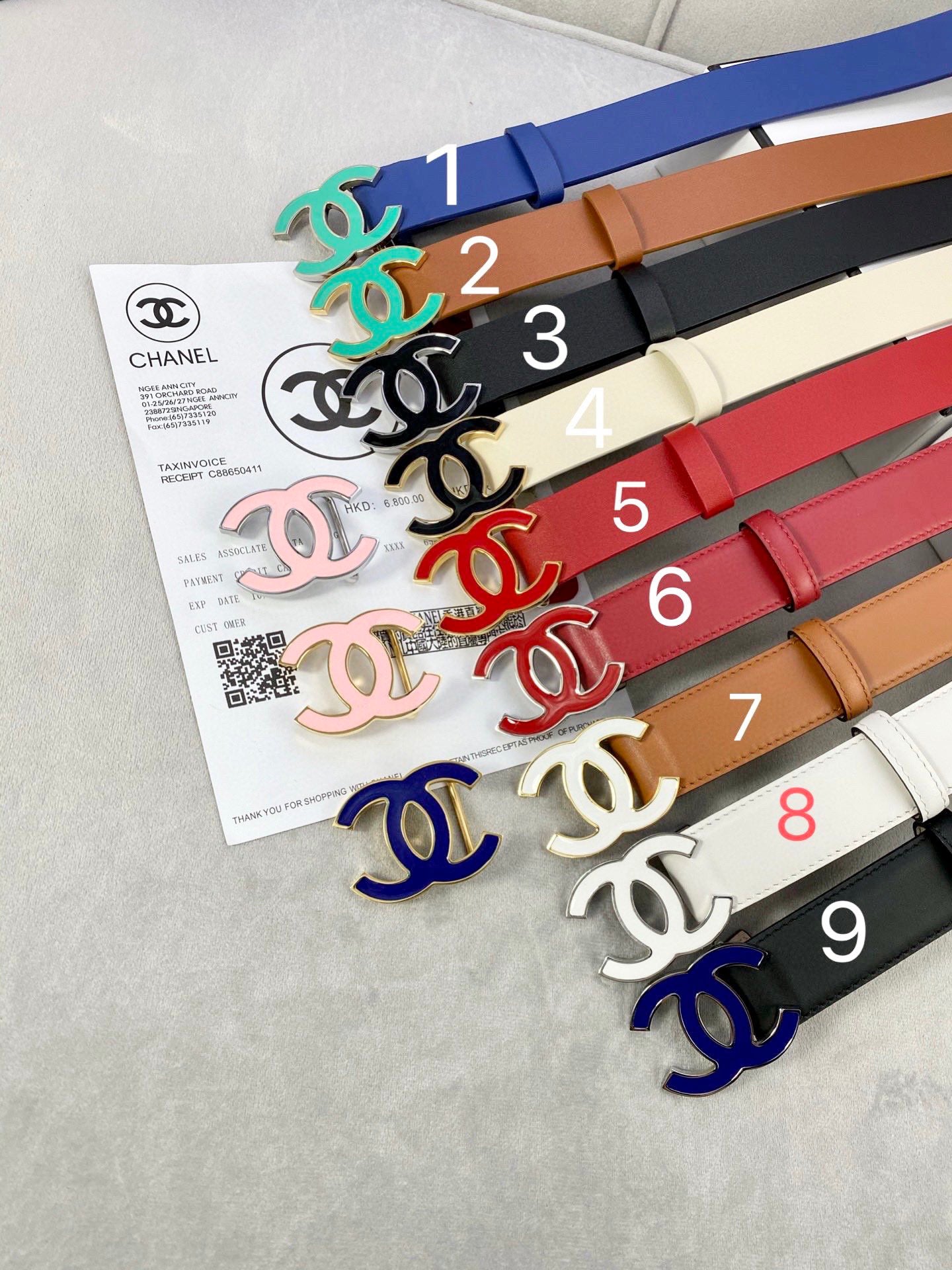 Assorted Chanel belts with colorful straps and logo buckles