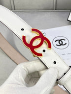 Close-up white Chanel belt with red logo buckle and metal eyelets