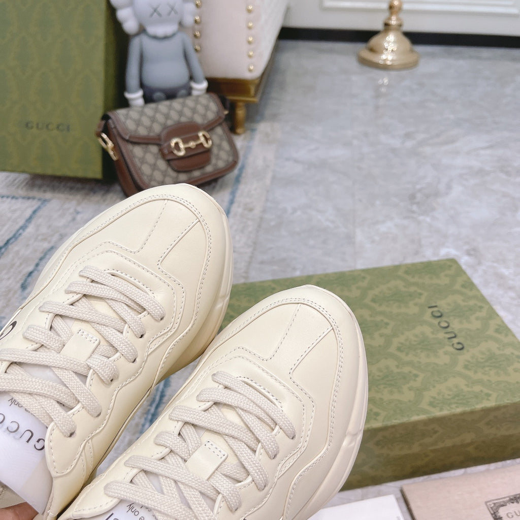 Gucci unisex sneakers from toe view, white uppers with lace-up and stitching
