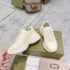 Gucci unisex sneakers, white pair shown from front and angle on green box