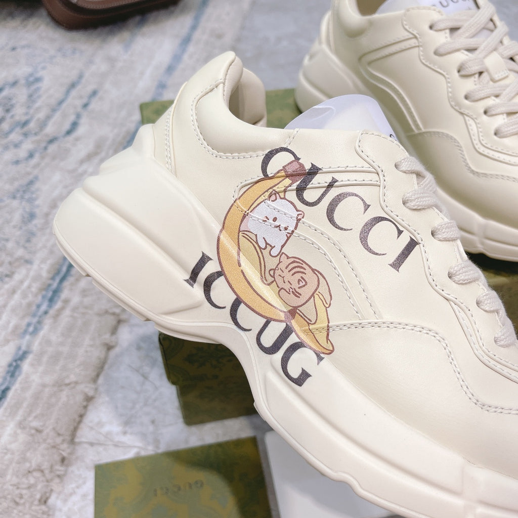 Close-up of Gucci unisex sneaker, white upper with colorful logo graphic and laces