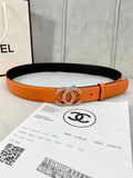 Orange leather belt with gold jeweled CC buckle, punched holes and black lining