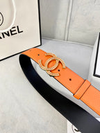 Orange leather belt with gold jeweled CC buckle and wide strap, open view