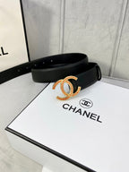 Chanel belt with black textured strap and gold-tone CC buckle