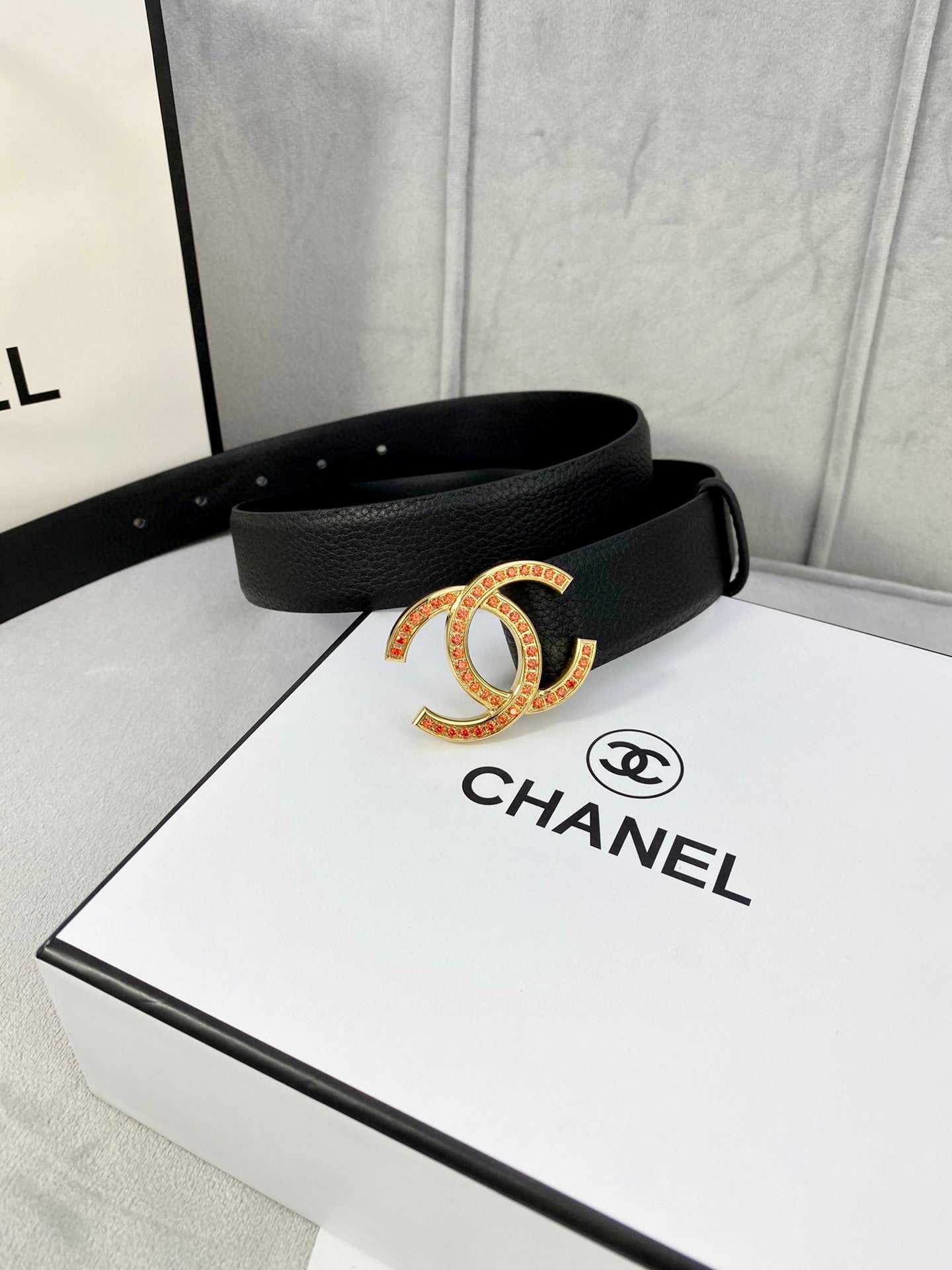 Chanel belt with black textured strap and gold-tone CC buckle