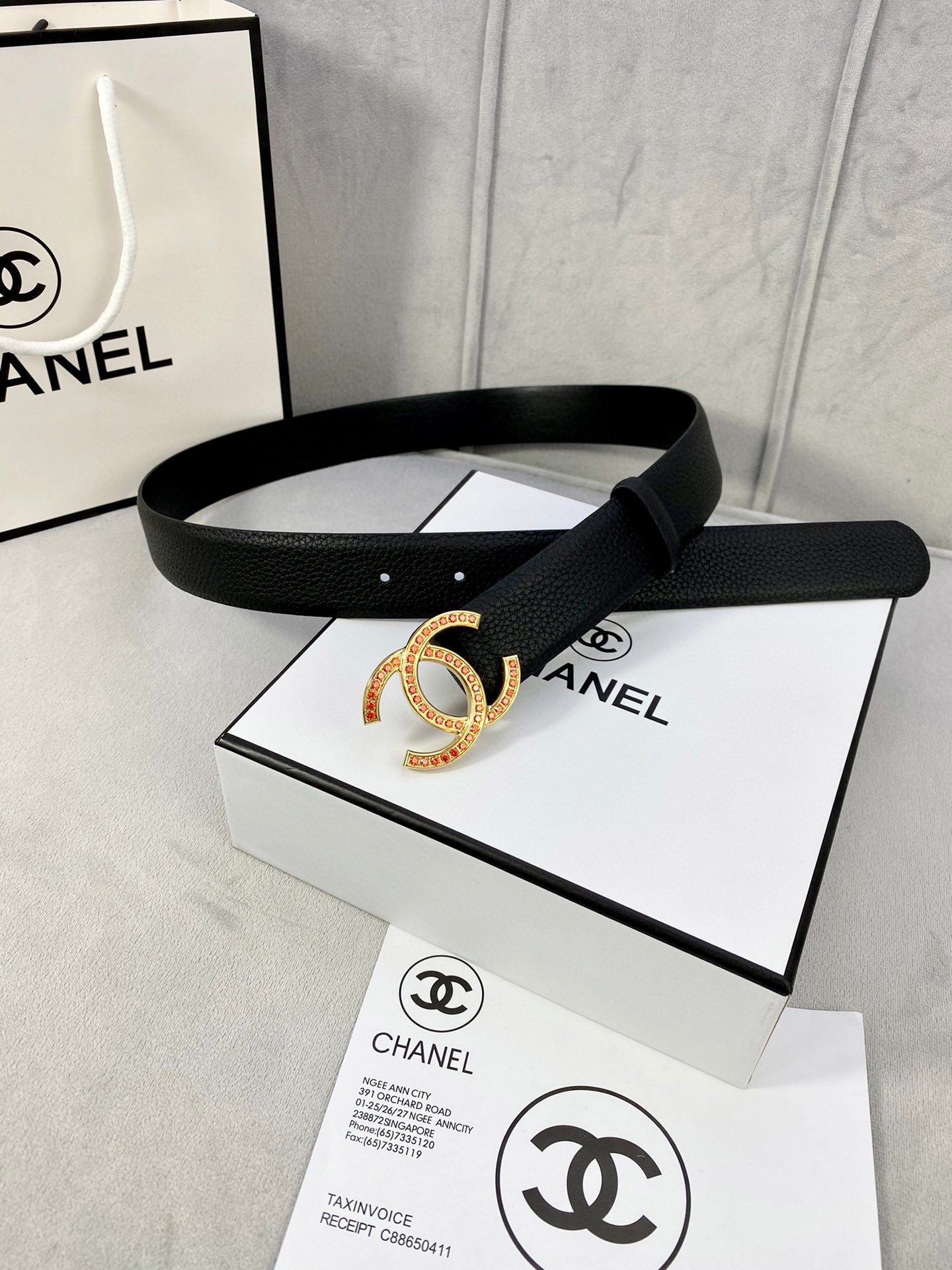 Chanel belt, black textured leather, gold-tone CC buckle with red stones