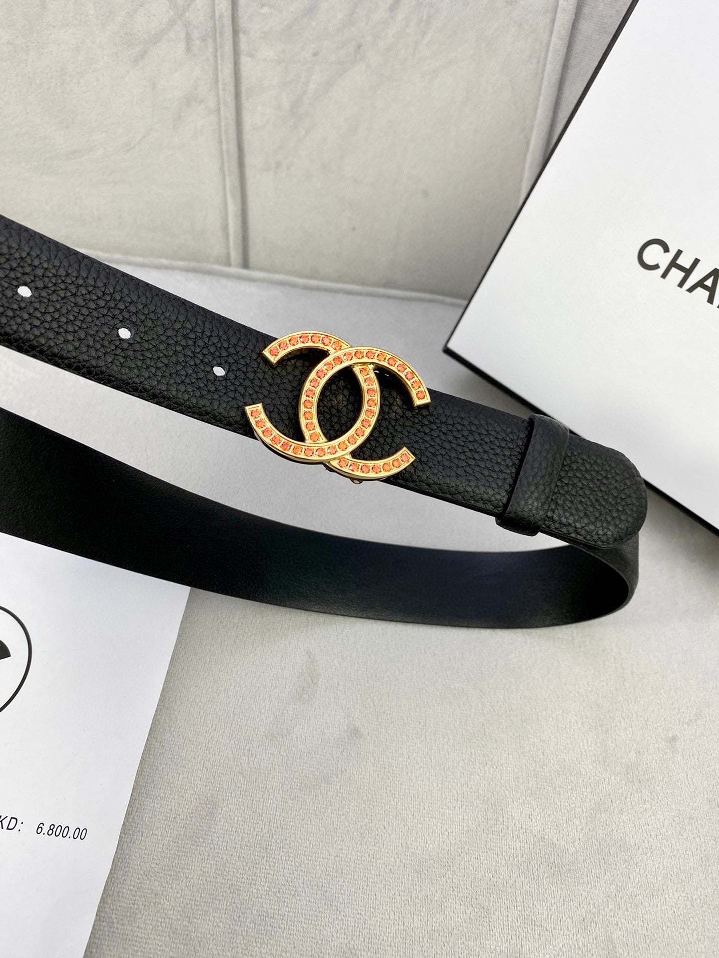 Chanel belt detail: black textured strap with gold-tone CC logo buckle