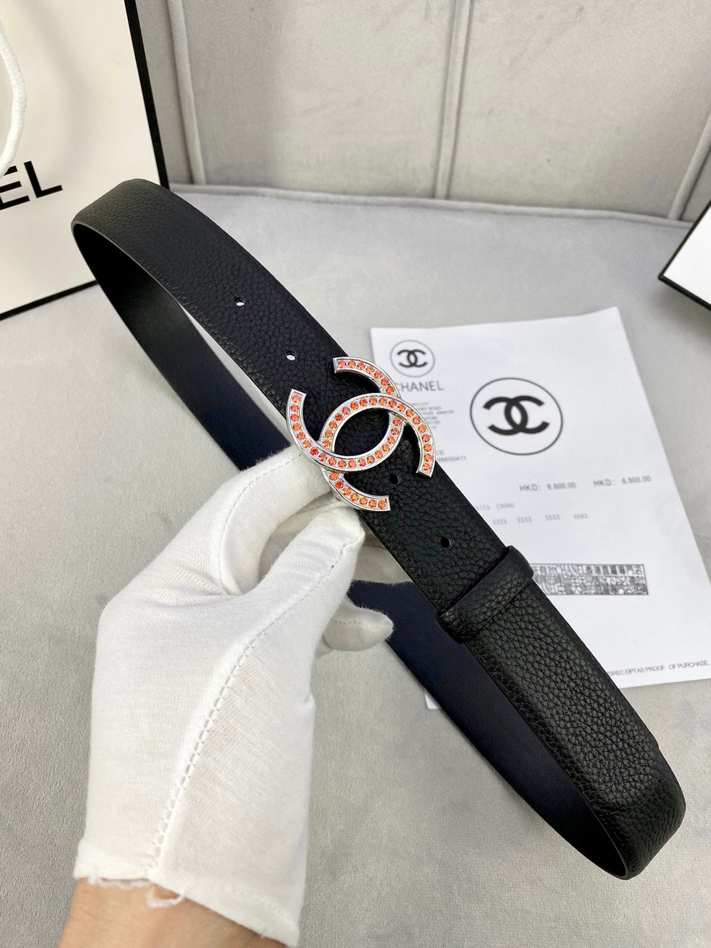 Chanel belt with black textured leather and CC buckle with red accents