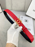 Red leather belt with Chanel CC buckle, black inner lining visible, full strap view.