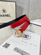 Red leather belt with large Chanel CC buckle, stacked in gift packaging with black strap.