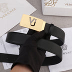 Black leather belt with gold rectangular buckle featuring VJ logo