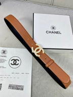 Tan leather belt with rhinestone CC buckle and two-tone underside