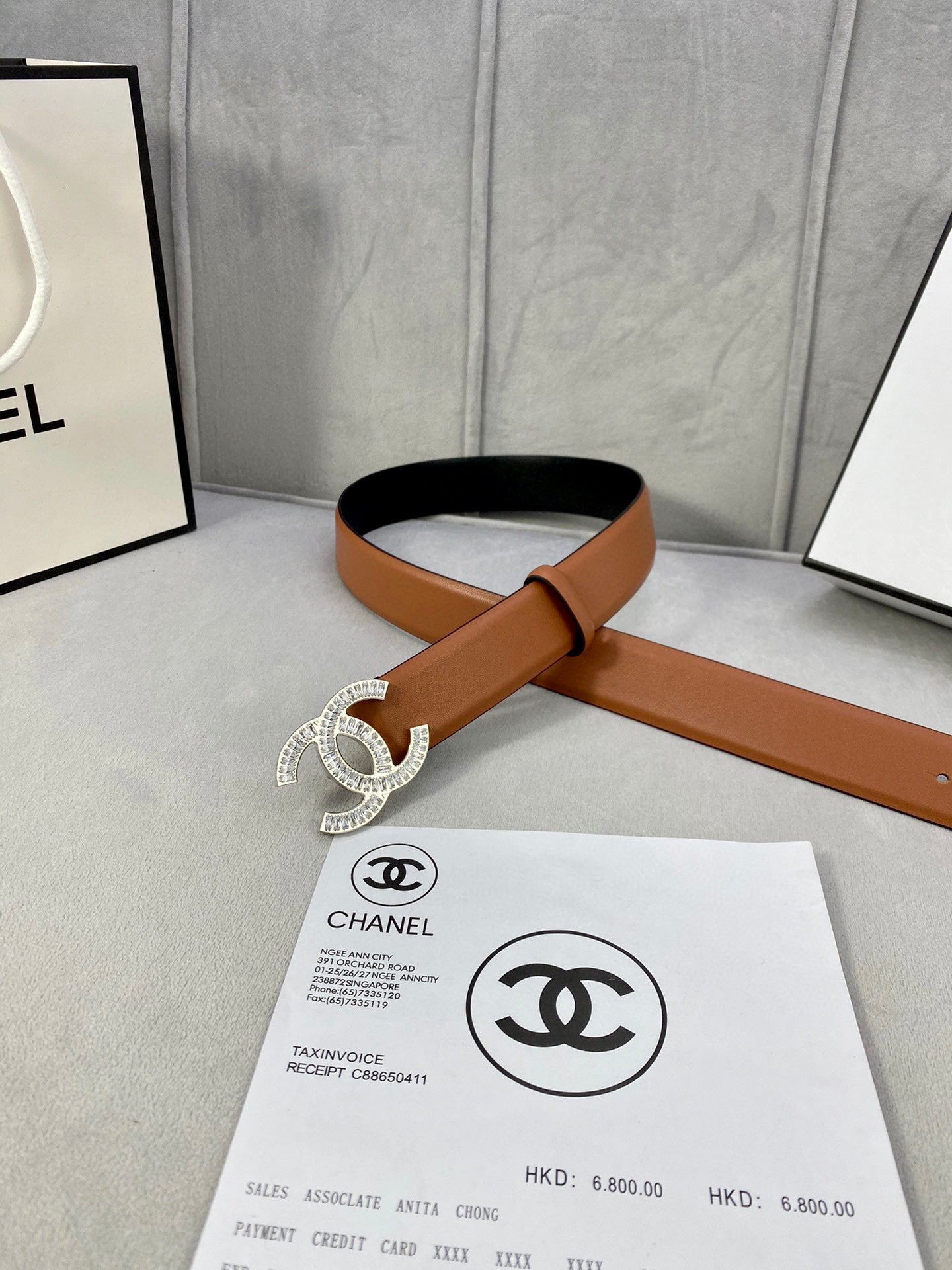 Tan leather belt with rhinestone CC buckle, shown with adjustable strap