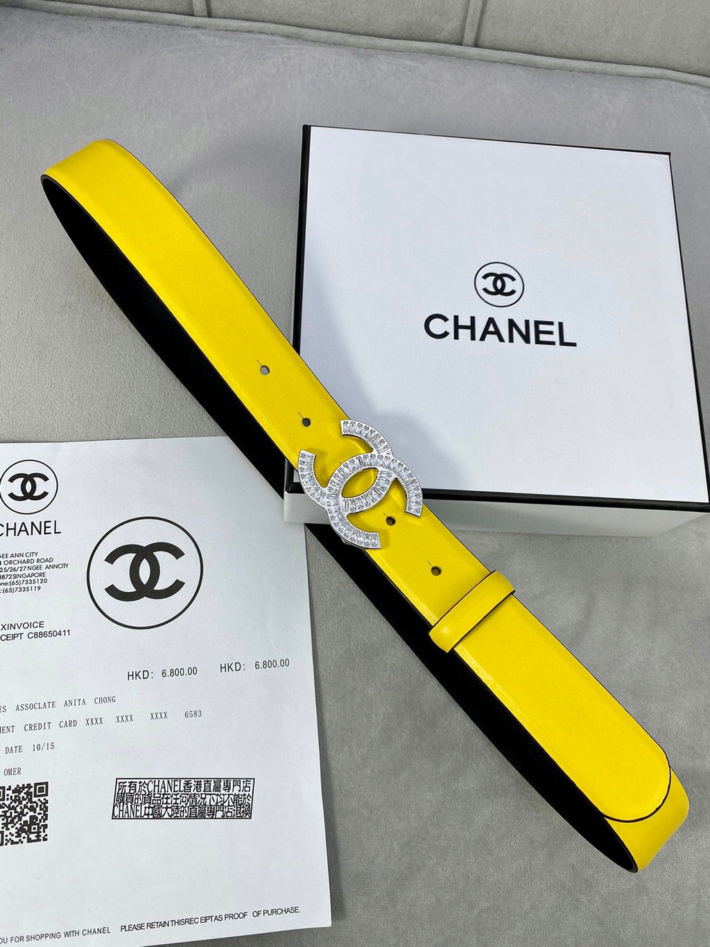 Yellow and black two-tone Chanel belt with silver rhinestone CC buckle