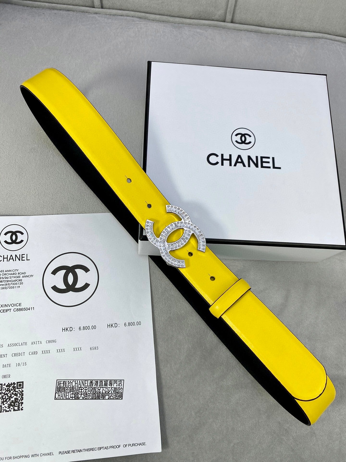 Yellow and black two-tone Chanel belt with silver rhinestone CC buckle