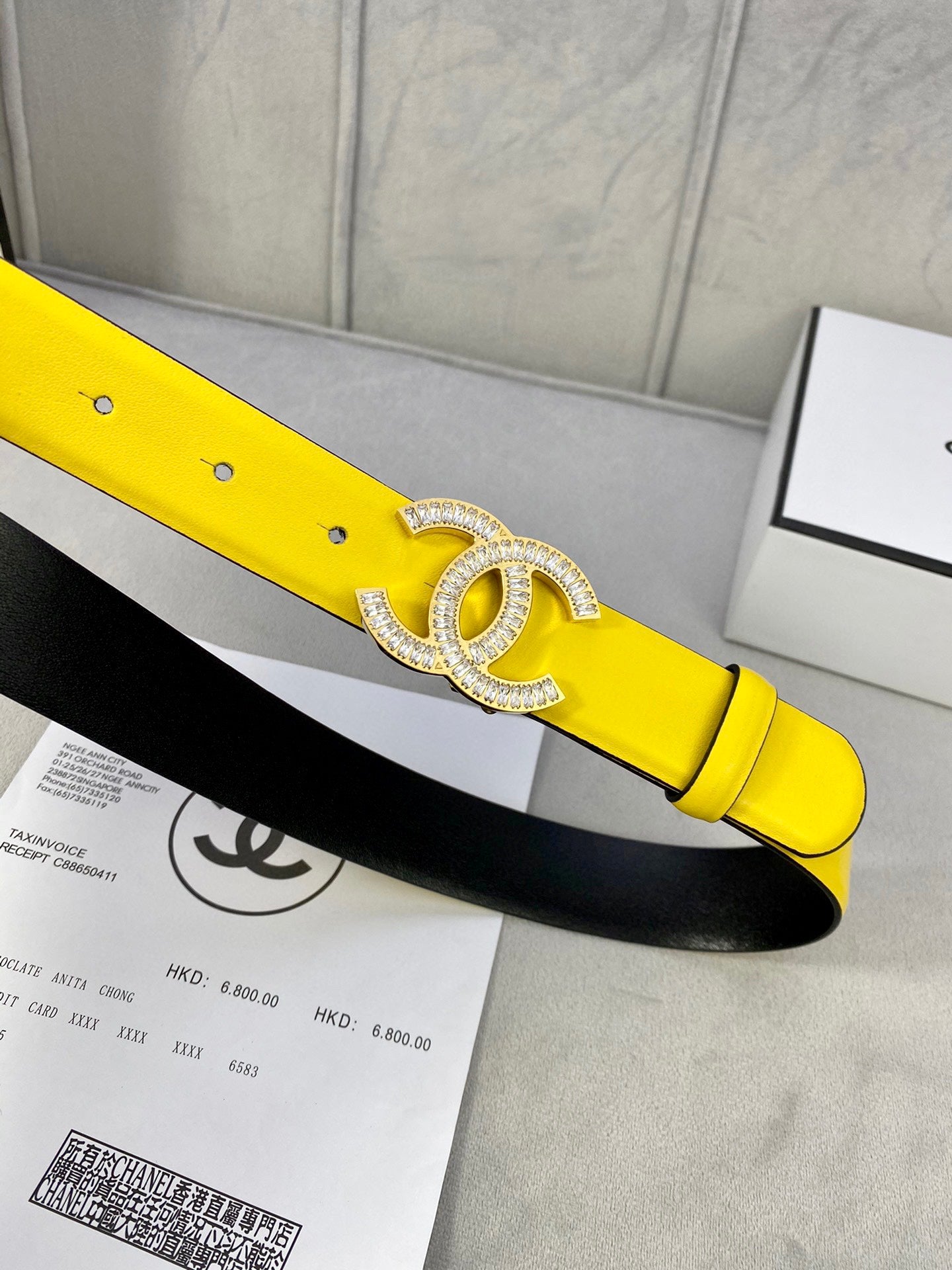 Yellow leather belt with adjustable holes and silver rhinestone CC buckle detail