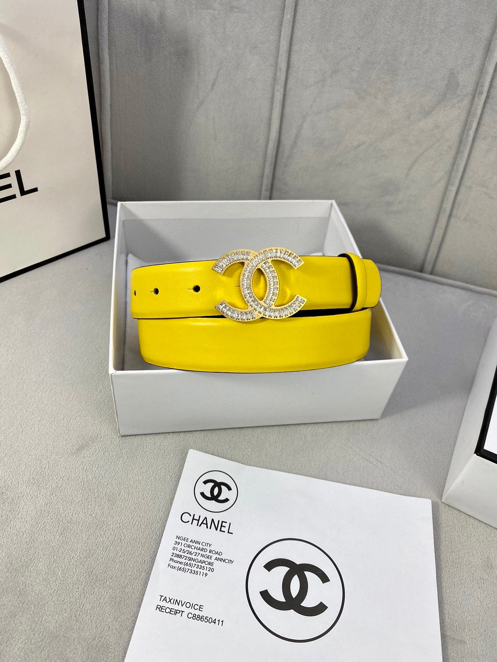 Yellow Chanel belt with silver rhinestone CC buckle, shown in gift box
