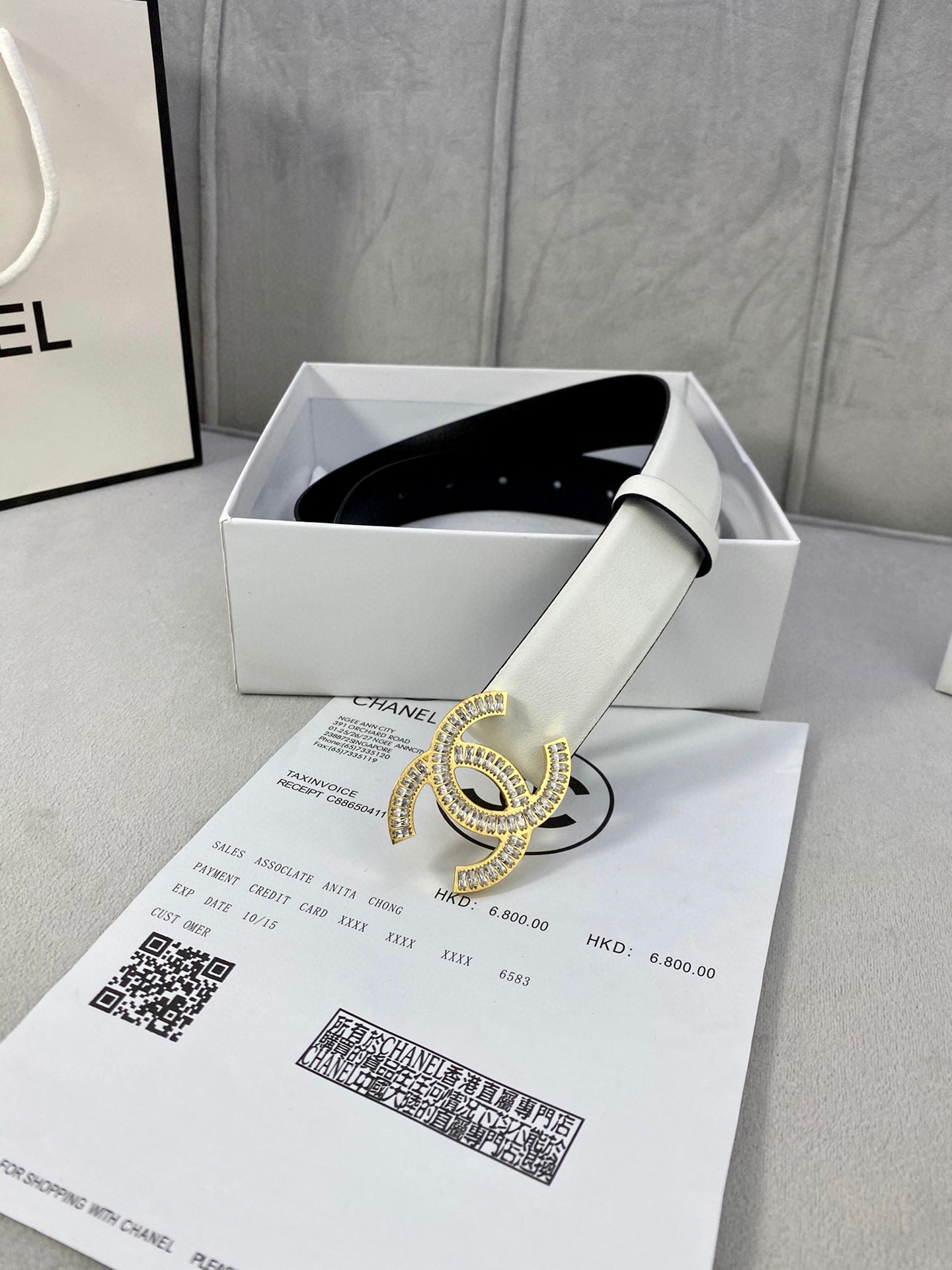 White leather belt with gold-tone rhinestone CC logo buckle and black interior