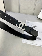 Black leather belt featuring a rhinestone CC emblem buckle and adjustable holes