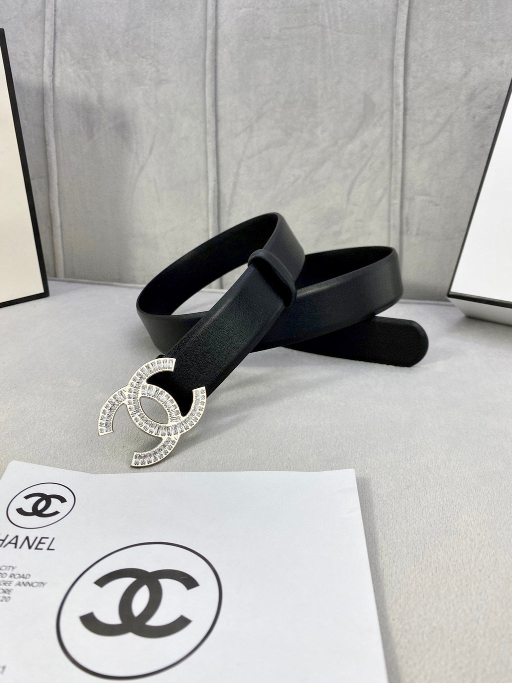 Black leather belt with rhinestone CC buckle and wide strap end