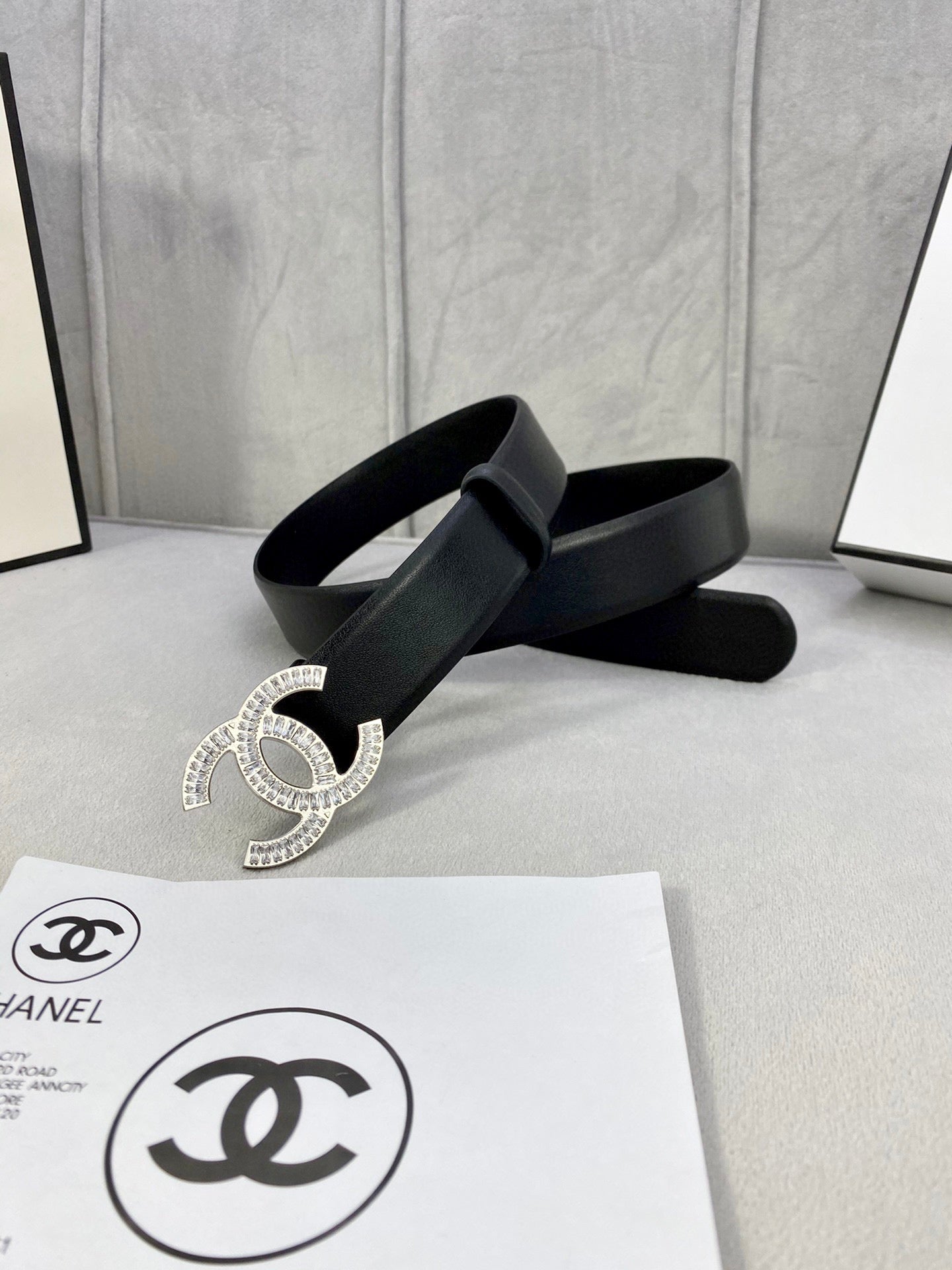 Black leather belt with rhinestone CC buckle and wide strap end