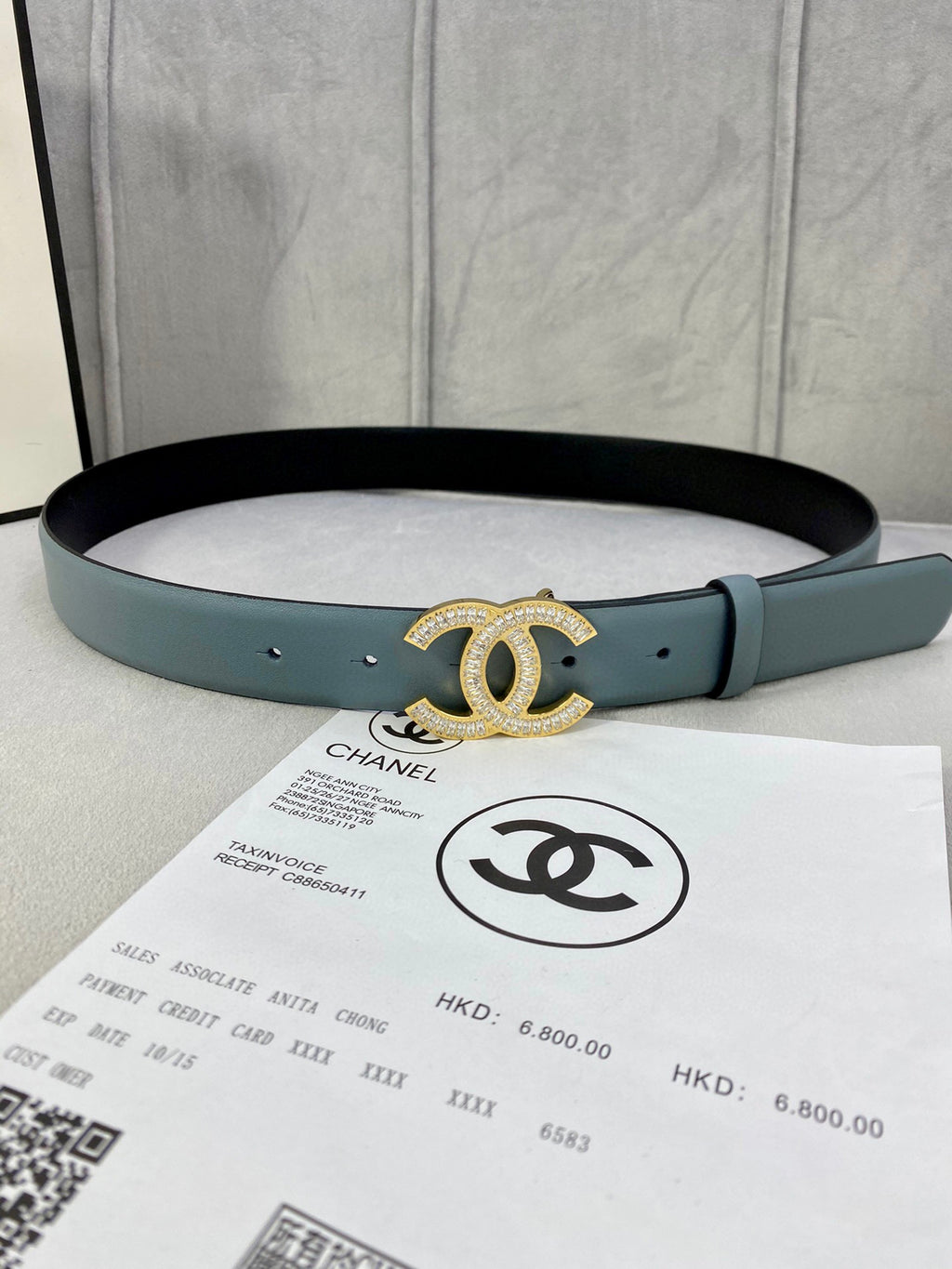 Light blue Chanel belt with gold-toned CC buckle and punched adjustment holes.