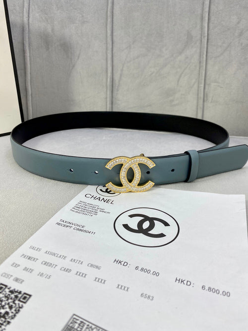 Light blue Chanel belt with gold-toned CC buckle and punched adjustment holes.